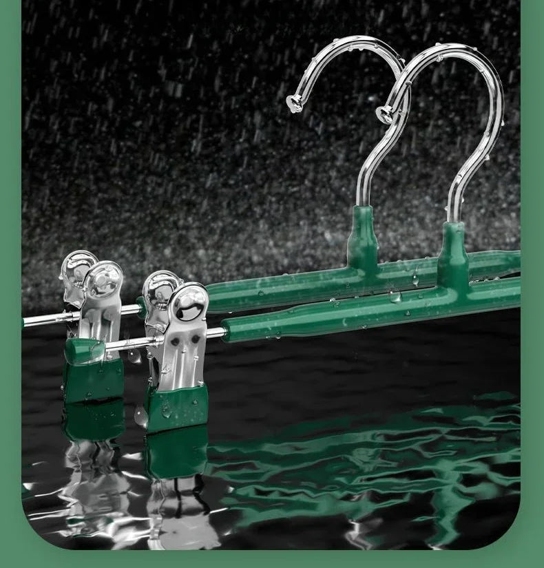 A set of five anti-slip stainless steel hangers with clips, colored green, are displayed against a dark background.