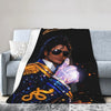 A graphic plush throw blanket featuring a portrait of Michael Jackson in a royal blue and gold outfit.
