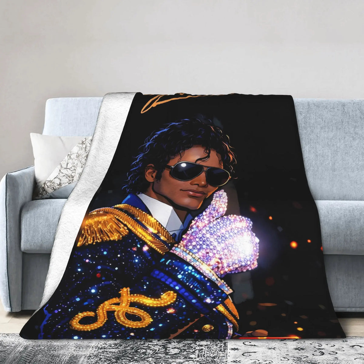 A graphic plush throw blanket featuring a portrait of Michael Jackson in a royal blue and gold outfit.