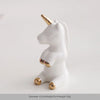 White ceramic elephant and rabbit jewelry holder with gold accents, displayed against a light background.