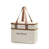 A beige insulated lunch bag with brown straps and a tan lining.