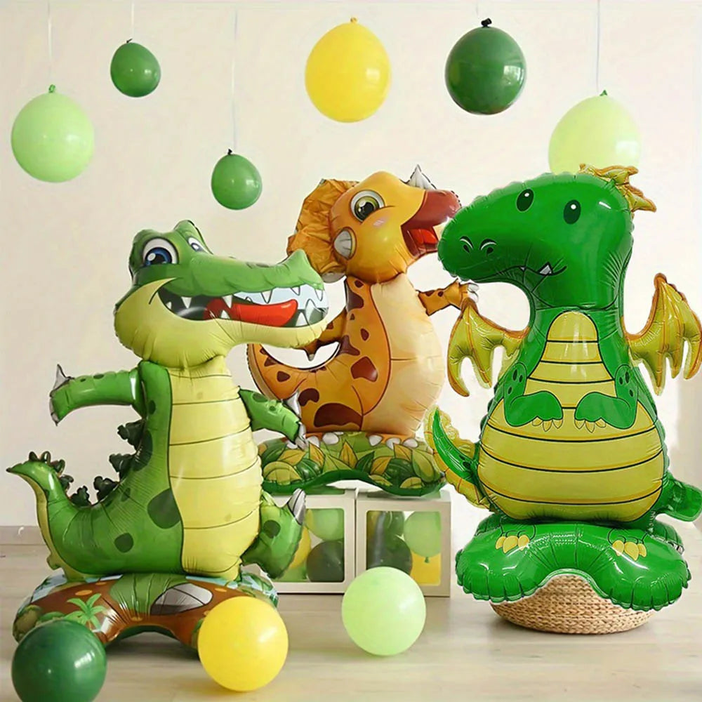 A collection of green and yellow dinosaur foil balloons hanging in the air.