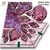 A roll of pink glitter African wax print fabric featuring purple and magenta floral patterns.