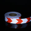 Roll of high-visibility reflective safety tape featuring red and white chevron patterns