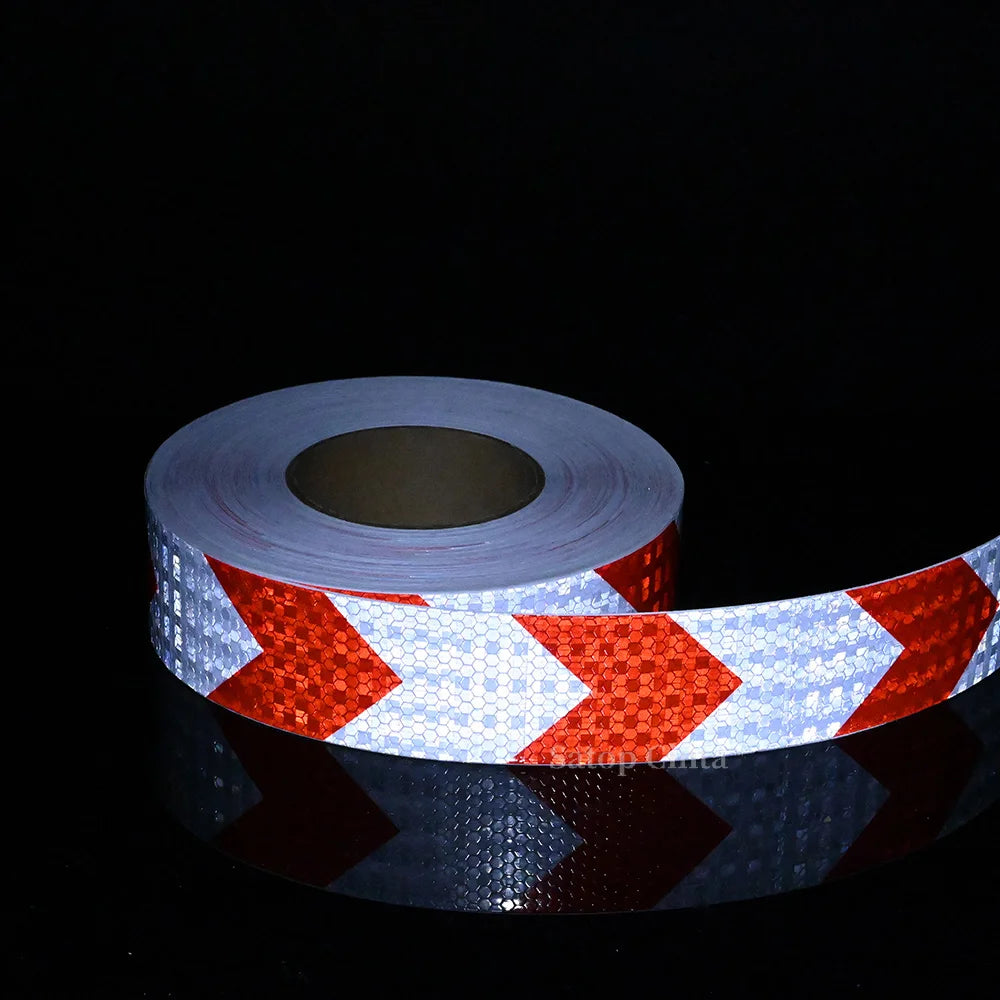 Roll of high-visibility reflective safety tape featuring red and white chevron patterns