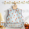 A light blue waterproof baby feeding bib with a sleeveless design featuring small orange and green fruit illustrations.