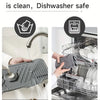 A hand is pouring water over a non-slip silicone kitchen sink mat with a drain tray, demonstrating easy cleaning.