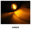 Close-up of an amber LED side marker light illuminating a bright yellow beam.