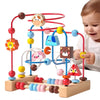 A wooden bead maze toy with colorful beads and a wooden base is being played with by a toddler.
