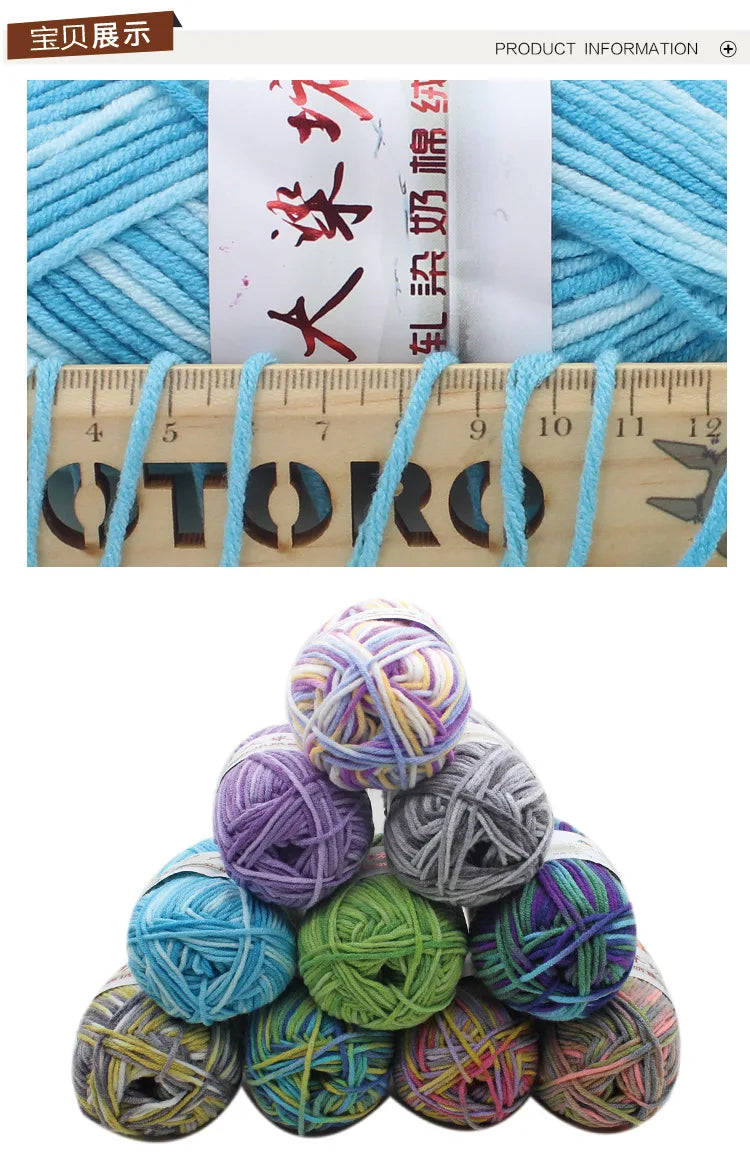 A pile of multicolored milk cotton blend yarn balls showing various shades of blue, purple, green, and gray.