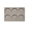 A gray silicone mold with six circular cavities for making soap or aromatherapy discs.