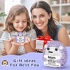 A smiling mother and child holding a handmade crochet hedgehog doll with an inspirational card