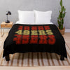 A black knit throw blanket featuring the text '49ERS 40ERS 40ERS' in yellow, orange, and red lettering.