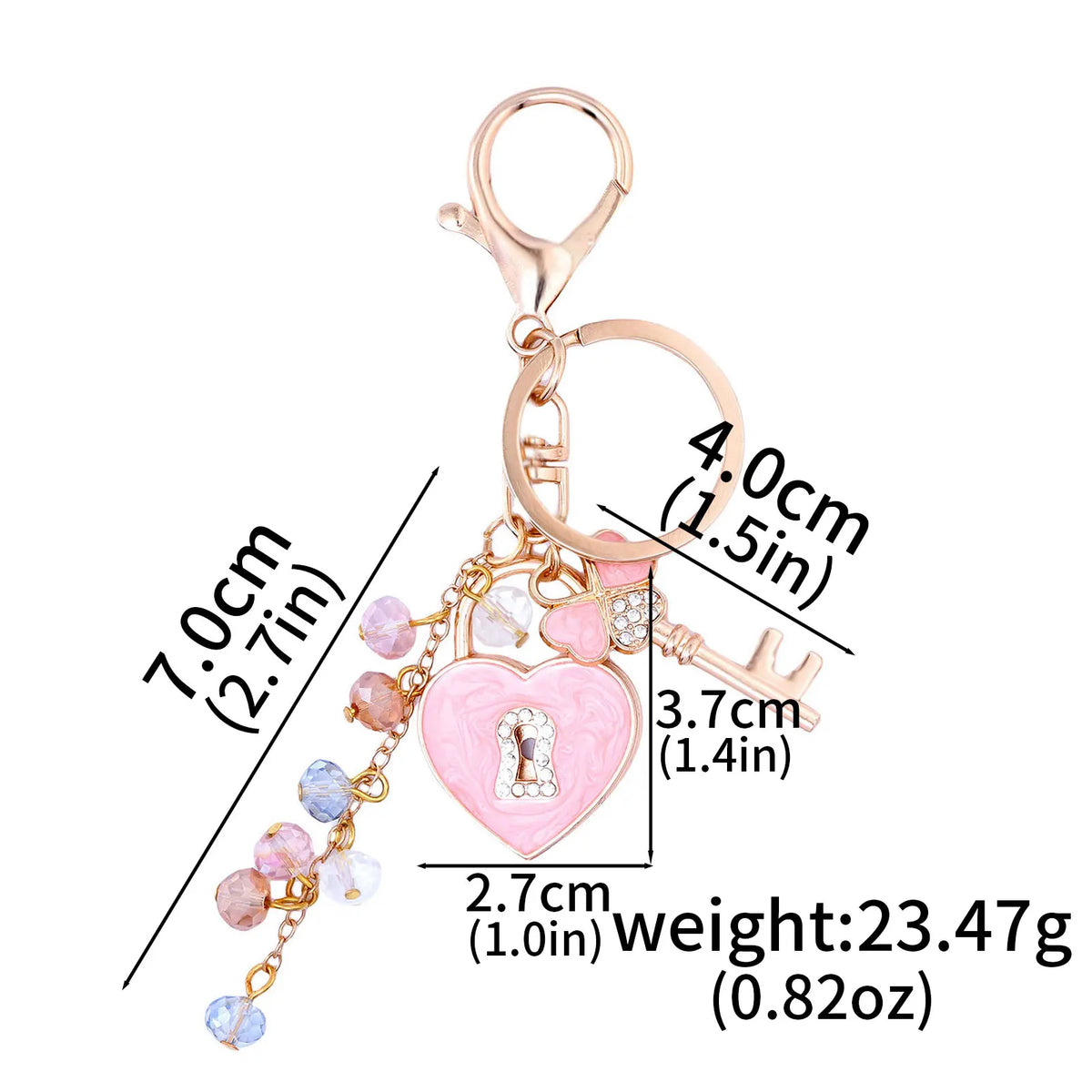 Gold-toned lock charm keychain featuring a heart and bow design with pink and clear rhinestones.