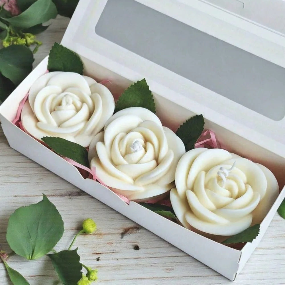 A white rose flower silicone mold set is displayed in a box with green leaves.