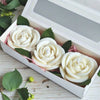 A white rose flower silicone mold set is displayed in a box with green leaves.