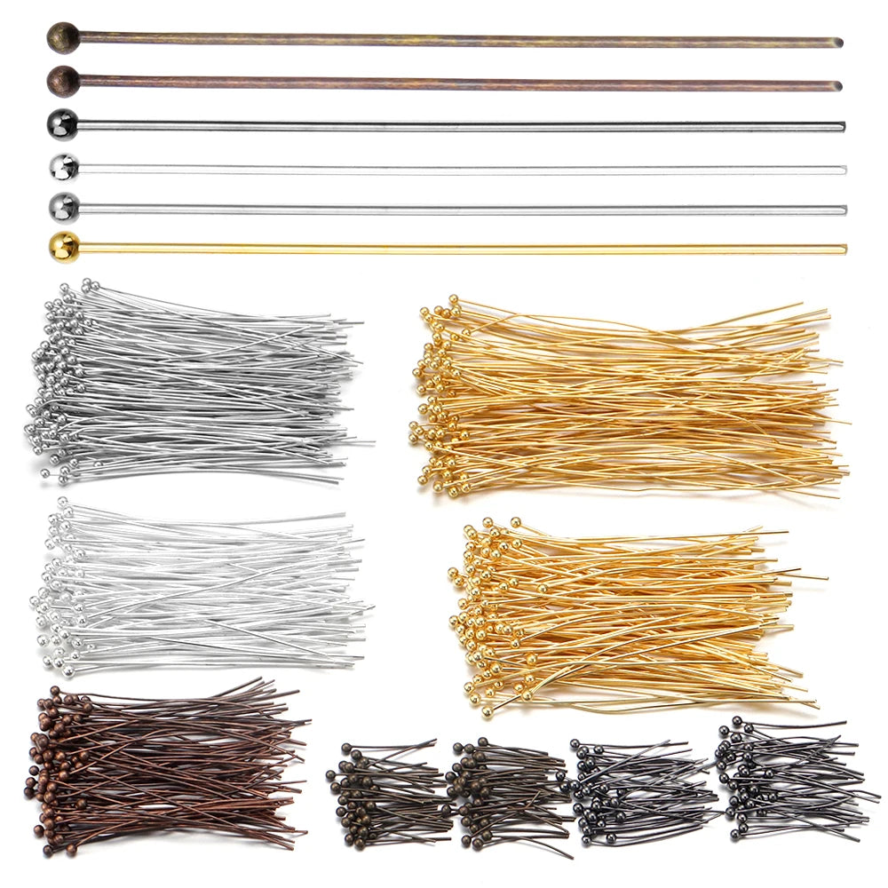 A collection of gold-plated brass ball head pins and various straight pins for jewelry making.