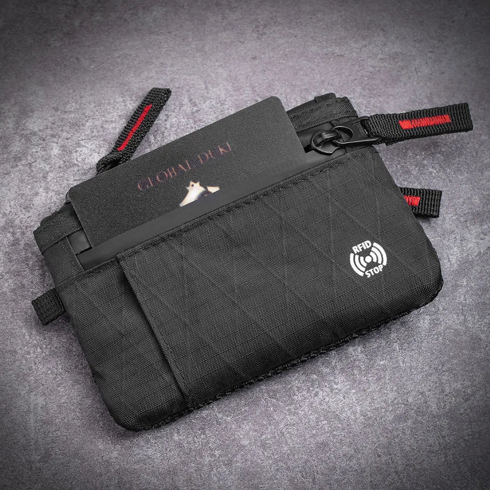 Black RFID-blocking travel wallet with a carabiner clip and a small white logo on the cover