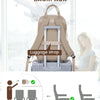 A tan personal item travel backpack with a luggage strap is shown next to a laptop and various items.