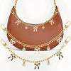 A brown leather bag with gold alloy chain handles decorated with pink bows and pearl drops.