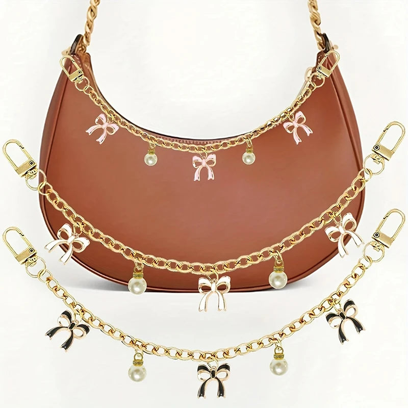 A brown leather bag with gold alloy chain handles decorated with pink bows and pearl drops.