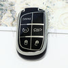 A black TPU car key fob cover with panic and lock buttons is shown against a light patterned background.