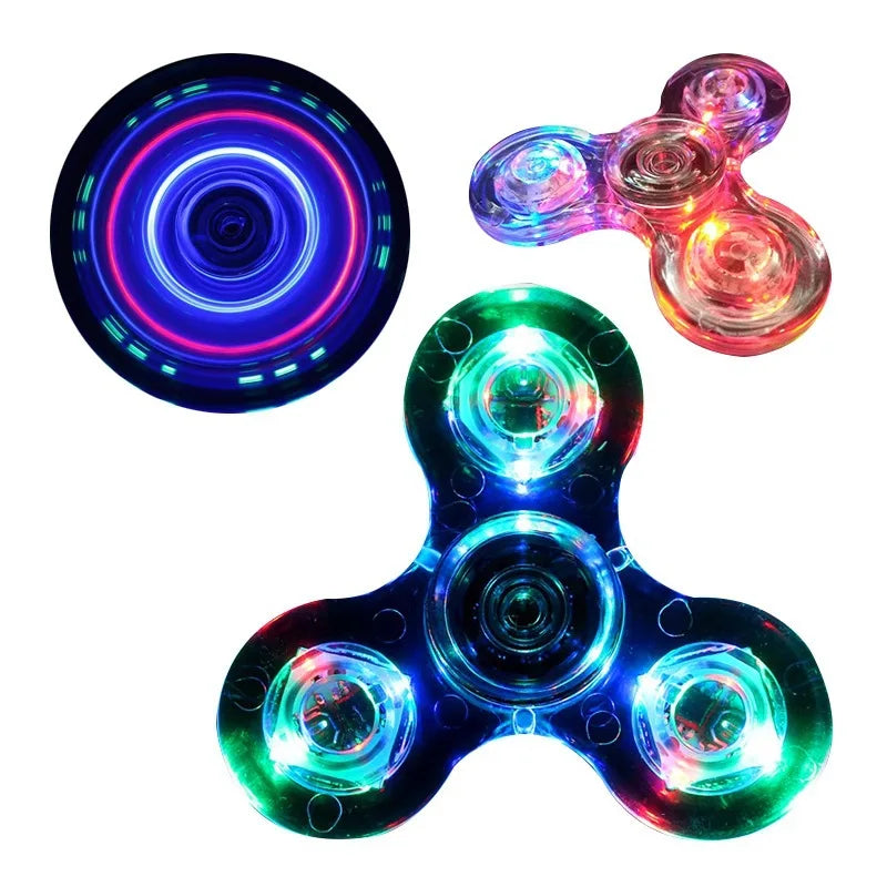A set of three glowing LED fidget spinners with various colors and designs.