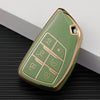 A light green durable TPU car key fob cover with gold accents shown on a dark surface.