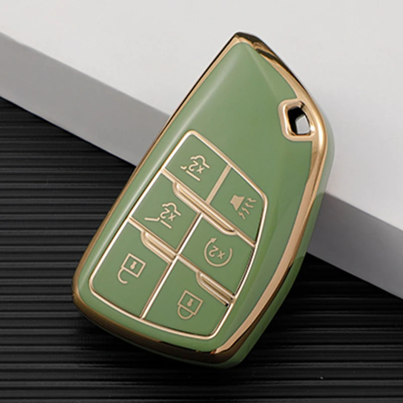 A light green durable TPU car key fob cover with gold accents shown on a dark surface.