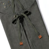 A close-up view of a dark olive green cotton canvas apron with drawstring ties and cross-back straps.