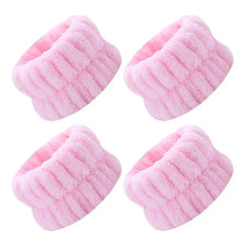 Pink microfiber wrist washing bands or face-saving cuffs with a ribbed texture