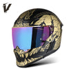 A black motorcycle helmet with gold and black graphic designs and a reflective visor.