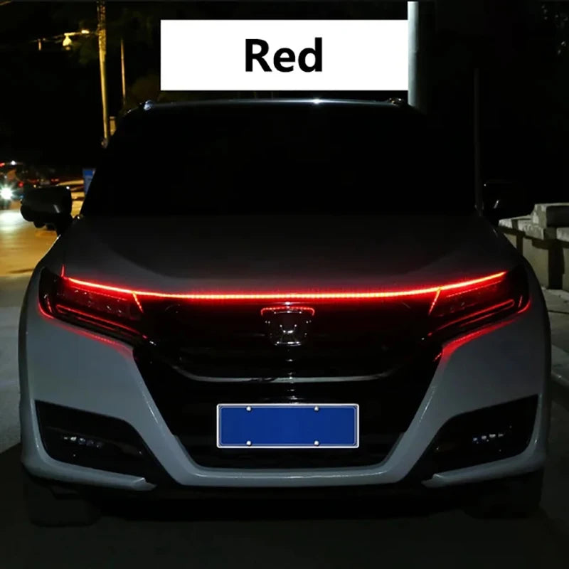 Close-up of a car's front grille showing a red LED engine hood light strip with a scan effect.
