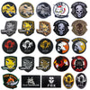 A collection of embroidered patches featuring various foxhound designs and skull motifs on black, gold, and olive backgrounds
