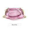 A small pink glossy clutch bag with gold metal hardware shown against a white background.