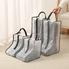 A set of clear waterproof boot storage bags with black handles resting on a light-colored carpet.