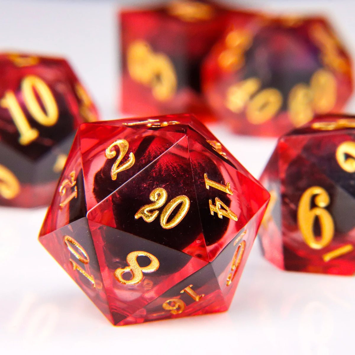 A close-up of a red liquid core resin die with a dragon eye design, showing the number 20.