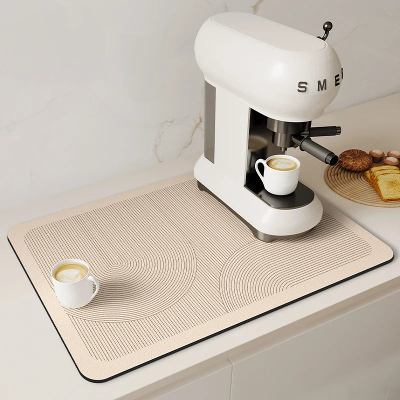 A white espresso machine is placed on a beige quick-dry diatom mud absorbent counter mat.