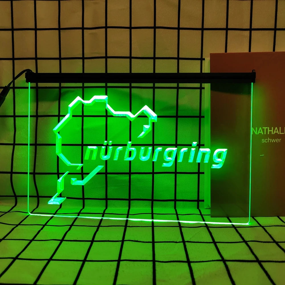 A neon sign shaped like the state of Nuremberg in bright green light displayed within a black frame.