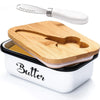 A white butter dish with a wooden lid and a stainless steel knife resting on the dish.