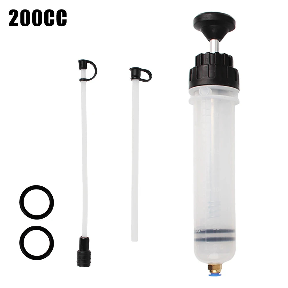 A clear plastic syringe with a black cap and a long white tube for manual fuel transfer or oil extraction.