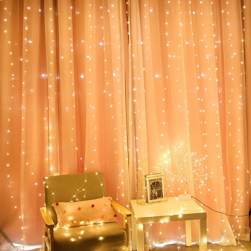 A light pink curtain backdrop decorated with fairy lights, featuring a chair and a small table.
