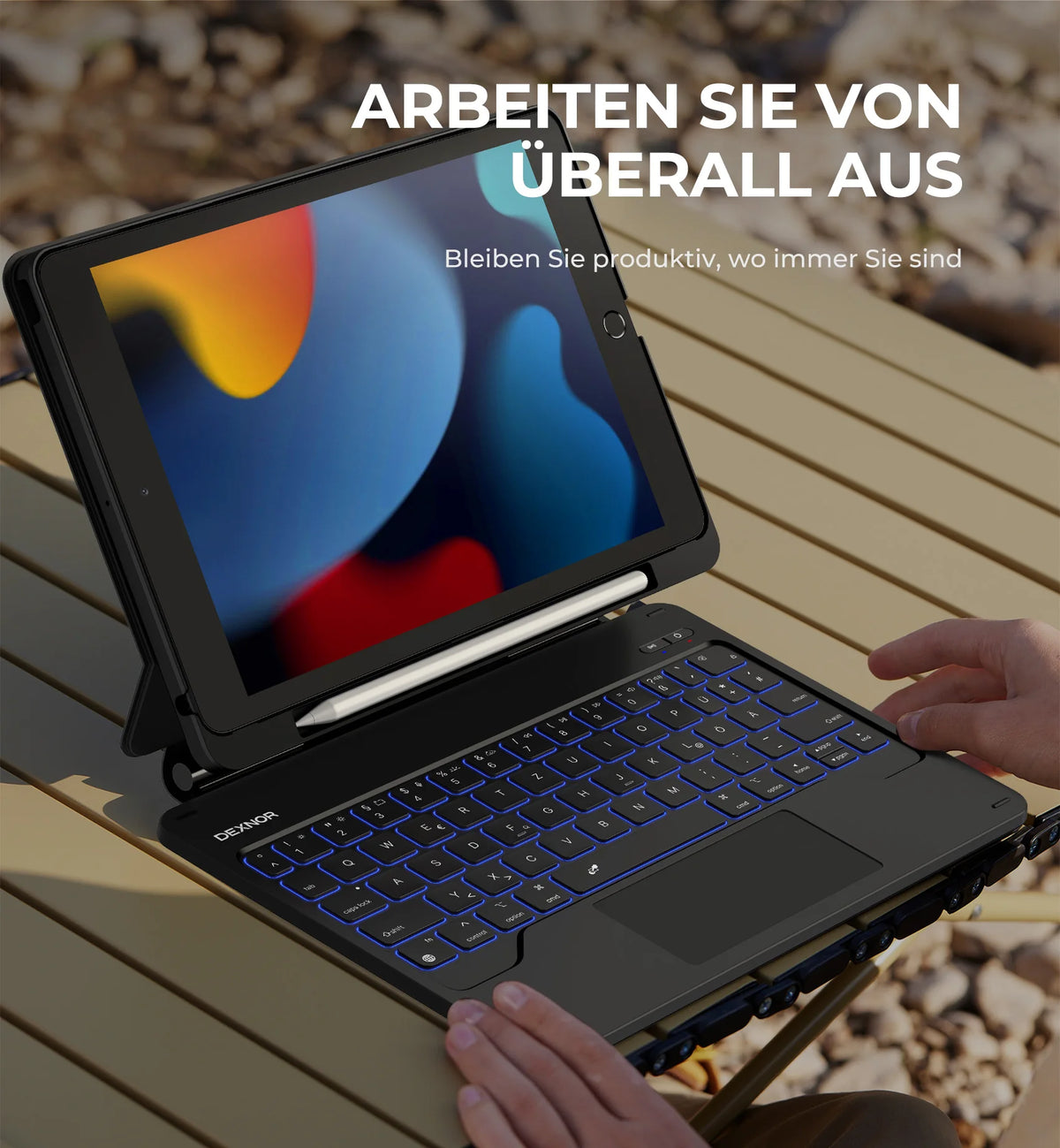 A person is using a black magnetic Bluetooth keyboard case with a trackpad for an iPad on a wooden surface.