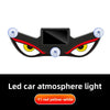 A black demon eye LED car window decal with yellow and red lights.