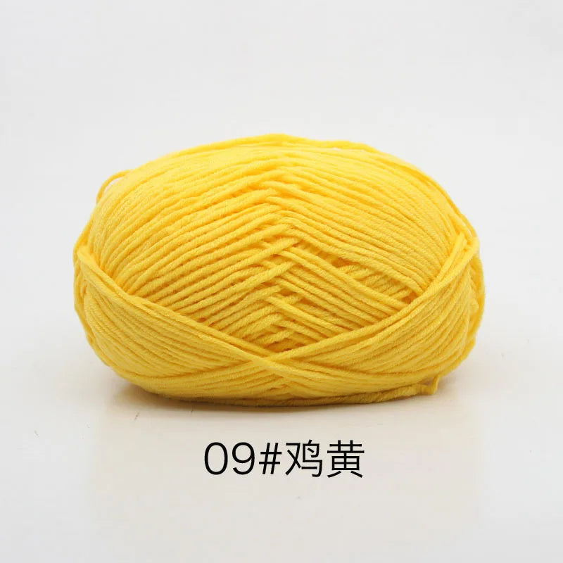 A ball of bright yellow 4-ply milk cotton yarn for knitting and crochet.
