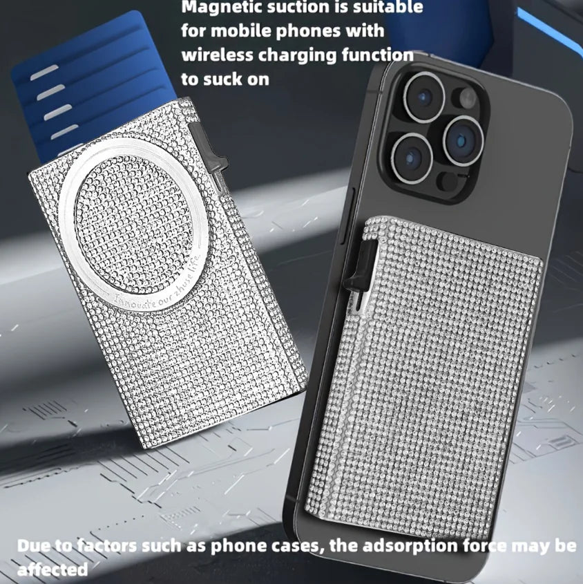 A slim aluminum pop-up card wallet with a textured surface is shown next to a smartphone demonstrating magnetic suction for w