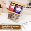 A clear stackable organizer for pantry storage featuring spice jars with bamboo lids and colorful labels.