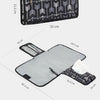 Black and white foldable waterproof baby changing pad with a carrying bag and a separate mat.
