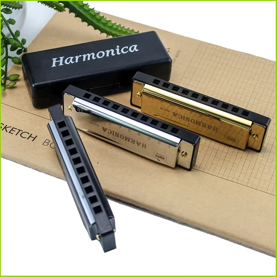 A harmonica is shown inside its protective case on a brown cardboard background.