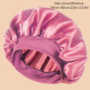 A pink satin wide brim shower cap shown from the side, highlighting its gathered texture.